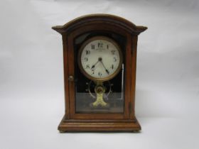 An early 20th Century oak cased Eureka clock with early electric movement and large balance wheel,
