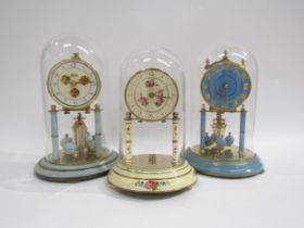 A group of three brass anniversary clocks under glass domes including Koma, Kundo and Kesn. Each