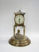 A 20th Century glass domed anniversary clock raised on a stepped circular base with front turn
