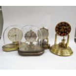 Four assorted anniversary clocks including Kundo electronic and Schatz, one lacking dome