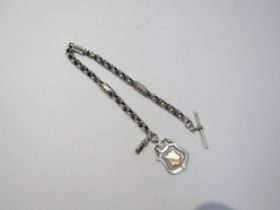 A silver watch chain with T -bar and fob