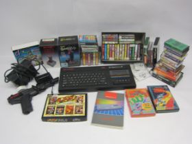 A Sinclair ZX Spectrum +2 computer with joysticks, gun and assorted games