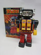 A boxed SH (Horikawa), Japan, battery operated plastic and tinplate robot with chest opening to