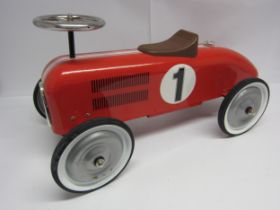 A Kalee pressed tin ride on racing car, 73cm long