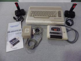 A Commodore 64 personal computer with power supply, datasette unit and two joysticks all together