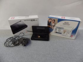 Two Nintendo DS Lites, one in a Brain training starter pack, along with a group on DS games