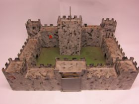 A large painted wooden castle, label to base "Hazelton Products"
