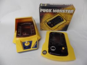 Two handheld arcade games including Frogger and Puck Monster. Puck is boxed.