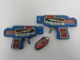 Two SY Toys (Yoneya), Japan, tinplate friction space guns in blue with litho printed images of