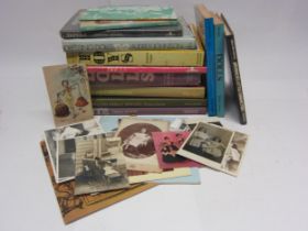 A collection of doll reference books and doll and toy related pictures and postcards