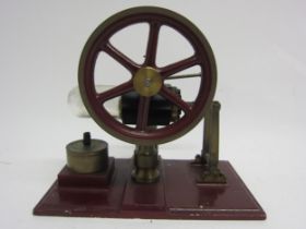 A Stirling hot air stationary engine with 9cm diameter flywheel, on heavy cast metal base, 15cm tall