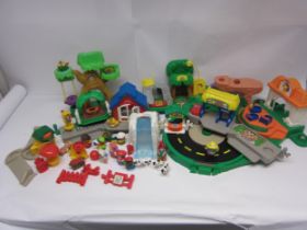 A collection of Fisher Price Little People sets and figures including roundabout, animal treehouse