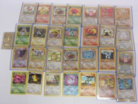 A collection of assorted Pokemon cards including base set Shadowless Holo Charizard (heavily