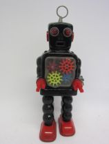 A KO (Yoshiya), Japan, sparking gear robot with black tinplate body and red feet, red plastic