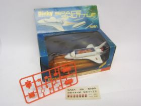 A Dinky Toys 364 diecast NASA Space Shuttle, with unbuilt plastic satellite, card satellite and