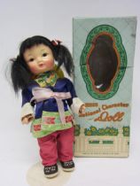 A boxed Chinese National Character doll, painted composition face and articulated body, in