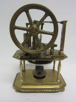 A Stirling hot air stationary engine with 8.5cm diameter flywheel, on ornate brass two tier frame