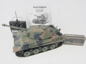 A Heng Long 1:16 scale radio control Snow Leopard tank with Battle Tank accessory parts and Sender