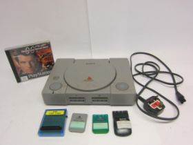 A Sony Playstation PS1 computer games console with three memory cards, PSX chip card and Tomorrow