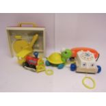 A small group of vintage Fisher Price toys including record player, pull-along telephone, turtle and
