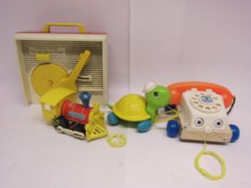 A small group of vintage Fisher Price toys including record player, pull-along telephone, turtle and