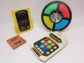 A group of four early 1980's handheld and table top electronic games to include Mego Corp Fabulous