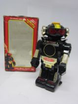 A boxed New Bright Tommy The Atomic Robot battery operated plastic robot, 26cm tall.