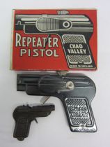 A boxed Chad Valley Repeater Pistol tinplate cap gun and a small German cap gun (2)