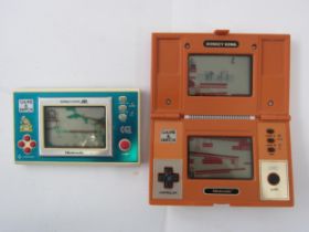 Two vintage Nintendo Game & Watch handheld electronic games to include DK-52 Donkey Kong and DJ-
