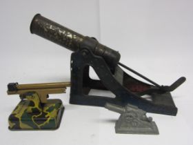A German tinplate cannon, stamped D.R.P.a, 18.5cm tall, together with a Crescent diecast field gun