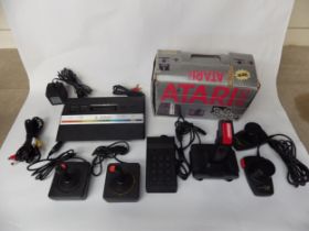 An Atari 2600 Video Computer System and a collection of Atari games including Mario Bros, Donkey