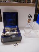 A three piece cased silver Holy communion set and a glass ewer with silver topped cork.