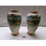 A pair of Japanese watermill vases, signature base ring.