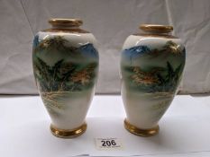 A pair of Japanese watermill vases, signature base ring.