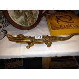 A brass crocodile nut cracker