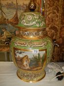 An early 20th century hand painted lidded vase, lid a/f.