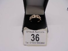 A white/yellow gold Greek key pattern diamond ring, size O, 3.5 grams
