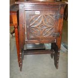 An early Victorian carved single door cabinet.