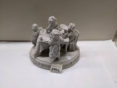 An early 20th century bisque porcelain figure group of a tea party, 22cm wide, 17cm deep, 18cm high,