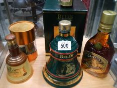 Two Bell's whisky bells with contents, a Glayva Scotch liquor and other whisky.