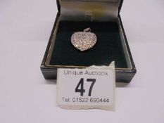 A 4.5 carat diamond and platinum heart pendant, 18.2 grams.