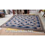 A blue & brown patterned carpet - 106 inches x 106 inches (COLLECT ONLY)