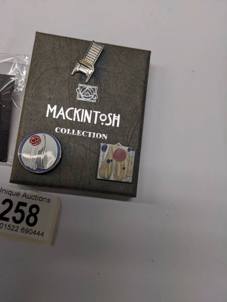 Three enamel Mackintosh collection pin badges and a Marcel Brewer badge of a table. - Image 2 of 3
