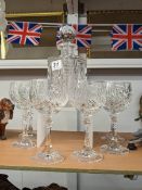 A cut glass decanter and six goblets.