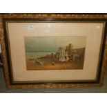 An early 20th century framed and glazed print featuring children on a beach, 88 x 65 cm.