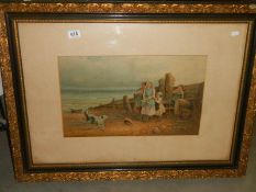 An early 20th century framed and glazed print featuring children on a beach, 88 x 65 cm.