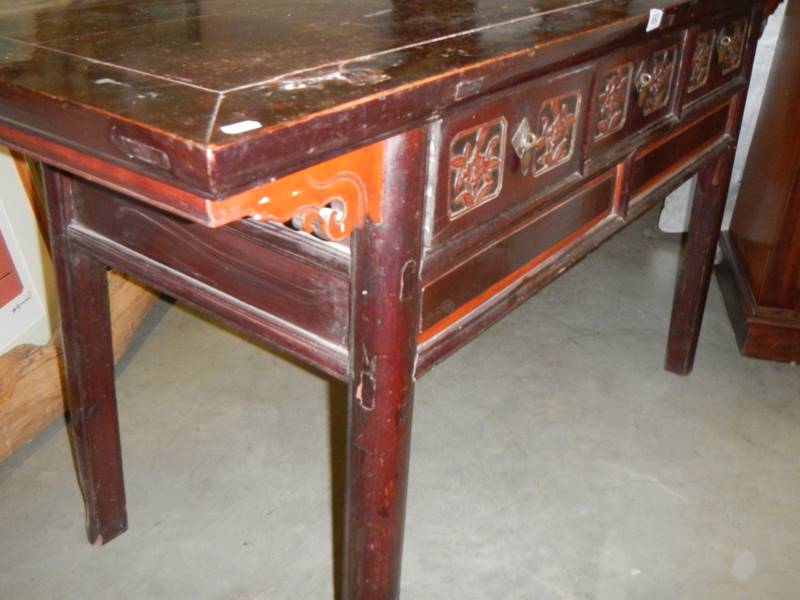 A Chinese carved three drawer hall table. - Image 2 of 3