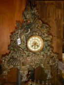 A Victorian cast iron 8 day clock with bronzed finish featuring horse, rider, dogs etc.,