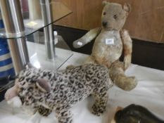 An old Teddy bear (in need of a little tlc) and a TY leopard.