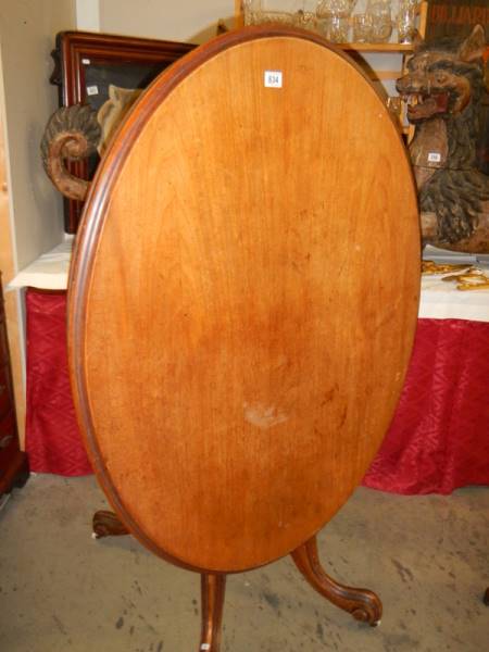 A Victorian mahogany oval tip top table. COLLECT ONLY.